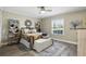 Cozy bedroom with neutral tones, wood floors, and a window providing ample natural light at 1136 Villa Ln # 96, Apopka, FL 32712