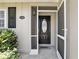 Close-up of the home's entry, showcasing a stylish front door with a screen door and house number at 1136 Villa Ln # 96, Apopka, FL 32712