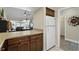 Kitchen area open to the living room, featuring wood cabinets and a white refrigerator at 1136 Villa Ln # 96, Apopka, FL 32712