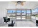 Light-filled lanai with tile flooring, wicker seating, and views of the yard and surrounding community at 1136 Villa Ln # 96, Apopka, FL 32712