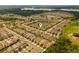 Aerial view of a community with picturesque ponds and lush greenery on a sunny day at 1151 Wildmeadow Run, Winter Park, FL 32792