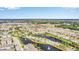 Aerial view of a scenic community featuring beautiful ponds, lush greenery, and well-maintained landscaping at 1151 Wildmeadow Run, Winter Park, FL 32792