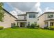 Home exterior showcases a large green lawn and manicured shrubbery at 1151 Wildmeadow Run, Winter Park, FL 32792