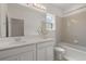 Well-lit bathroom with double sink vanity and tiled shower-tub combination at 1151 Wildmeadow Run, Winter Park, FL 32792