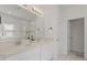 Bright bathroom features dual sinks, a large mirror, and a glass enclosed shower with a tiled backsplash at 1151 Wildmeadow Run, Winter Park, FL 32792
