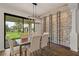 Dining area with modern light fixture, wine rack, and view of the backyard at 1151 Wildmeadow Run, Winter Park, FL 32792