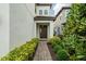 Inviting front entrance with a brick walkway leading to a charming covered porch and front door at 1151 Wildmeadow Run, Winter Park, FL 32792