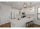 Stylish kitchen with white cabinets, quartz countertops, stainless steel appliances, and a breakfast bar at 1151 Wildmeadow Run, Winter Park, FL 32792