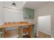 Functional laundry room with custom-built wooden countertops and sage green cabinets at 1151 Wildmeadow Run, Winter Park, FL 32792