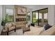 Bright living room with a decorative fireplace and large sliding glass doors to the screened patio at 1151 Wildmeadow Run, Winter Park, FL 32792
