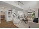 Bright, open-concept living room with soaring ceilings, wood floors, and access to dining area and staircase at 1151 Wildmeadow Run, Winter Park, FL 32792