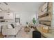 Spacious living room features a decorative stone fireplace and seamlessly connects to the kitchen area at 1151 Wildmeadow Run, Winter Park, FL 32792