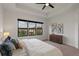 Bright main bedroom boasts tray ceiling and a large window with neighborhood views at 1151 Wildmeadow Run, Winter Park, FL 32792