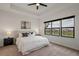 Serene main bedroom with tray ceiling, large windows overlooking the water, and neutral décor at 1151 Wildmeadow Run, Winter Park, FL 32792