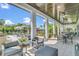 Inviting covered patio with comfortable seating, providing a relaxing outdoor space with ample shade at 1151 Wildmeadow Run, Winter Park, FL 32792