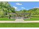 Outdoor picnic area with multiple tables and charcoal grills set on a manicured lawn, providing scenic views at 1151 Wildmeadow Run, Winter Park, FL 32792