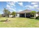 Expansive backyard with a well-maintained lawn, mature trees, and a screened-in patio, perfect for outdoor enjoyment at 1265 Zeek Ridge St, Clermont, FL 34715