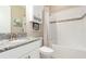 Bathroom features a white vanity with a granite countertop, a toilet, and a tiled shower and tub at 1265 Zeek Ridge St, Clermont, FL 34715