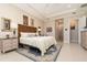 Comfortable bedroom with tile floors, neutral decor, and ensuite bathroom access at 1265 Zeek Ridge St, Clermont, FL 34715