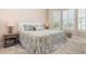 Bedroom with large bed, matching side tables and lamps, and shuttered windows for plenty of natural light at 1265 Zeek Ridge St, Clermont, FL 34715