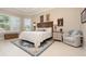 Comfortable bedroom with large windows, tile floors, neutral decor, and decorative rug at 1265 Zeek Ridge St, Clermont, FL 34715
