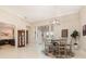 Bright and airy dining area with a view of the front entrance, complemented by a modern chandelier and neutral decor at 1265 Zeek Ridge St, Clermont, FL 34715