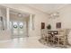 Elegant dining area with a view of the front entrance, featuring a stylish chandelier and seating for six at 1265 Zeek Ridge St, Clermont, FL 34715