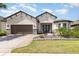 Charming single-story home featuring a brick driveway, two-car garage, and a beautifully landscaped front yard at 1265 Zeek Ridge St, Clermont, FL 34715