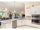 Open-concept kitchen with granite countertops, stainless steel appliances, and adjacent dining area at 1265 Zeek Ridge St, Clermont, FL 34715