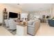 Bright living room with tile flooring, neutral walls, and modern furnishings that flow into the adjacent dining area at 1265 Zeek Ridge St, Clermont, FL 34715