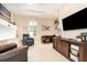 Comfortable living room with tile floors, entertainment center and leather seating at 1265 Zeek Ridge St, Clermont, FL 34715