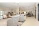 Spacious living area with tile flooring and neutral tones, connecting seamlessly to the dining and kitchen spaces at 1265 Zeek Ridge St, Clermont, FL 34715