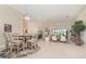 Open-concept living space with a dining area, seamlessly flowing into the cozy living room with access to the outdoors at 1265 Zeek Ridge St, Clermont, FL 34715