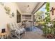 Relaxing outdoor patio with comfortable seating, plants, and a view of the backyard, ideal for entertaining at 1265 Zeek Ridge St, Clermont, FL 34715