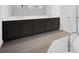 Elegant bathroom with a double vanity, dark cabinets, tiled flooring, and luxurious fixtures at 12863 Harvest Rain Ave, Winter Garden, FL 34787