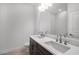Bathroom featuring double sinks, a large mirror, and modern fixtures at 12863 Harvest Rain Ave, Winter Garden, FL 34787