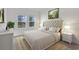 Serene bedroom with neutral tones, plush carpeting, and natural light streaming through the windows at 12863 Harvest Rain Ave, Winter Garden, FL 34787