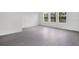 Bright and spacious room with multiple windows, wood-look tile flooring, and white walls at 12863 Harvest Rain Ave, Winter Garden, FL 34787