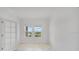 Bright and airy room with white walls, wood floors, and natural light, perfect for an office or guest room at 12863 Harvest Rain Ave, Winter Garden, FL 34787