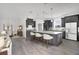 Open-concept kitchen features an island with barstool seating and stainless steel appliances at 12863 Harvest Rain Ave, Winter Garden, FL 34787