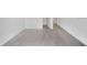 Spacious room showcasing light gray, wood-style flooring and neutral-colored walls at 12863 Harvest Rain Ave, Winter Garden, FL 34787