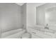 Bathroom with tiled walls, a bathtub, toilet, and a vanity with a white countertop at 12869 Harvest Rain Ave, Winter Garden, FL 34787