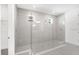 Large, modern bathroom with walk-in shower featuring tile walls and a neutral color palette at 12869 Harvest Rain Ave, Winter Garden, FL 34787