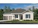 Charming one-story home featuring a beige exterior, attached garage, and well-manicured lawn at 12869 Harvest Rain Ave, Winter Garden, FL 34787