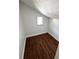 Finished attic room featuring sleek flooring, fresh paint, and a window allowing natural light to fill the space at 1310 Polk City Rd, Haines City, FL 33844
