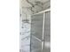Modern bathroom showcasing marbled tile walls and a sleek shower with glass doors, creating a luxurious and functional space at 1310 Polk City Rd, Haines City, FL 33844