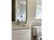 Bathroom with a toilet, quartz countertops, bright light fixture, and a mirror reflecting the shower at 1310 Polk City Rd, Haines City, FL 33844