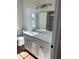 Bright bathroom featuring a modern vanity, quartz countertops, and sleek lighting fixtures at 1310 Polk City Rd, Haines City, FL 33844