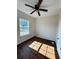 Bedroom with vinyl plank flooring, ceiling fan with light, fresh paint, and ample sunlight at 1310 Polk City Rd, Haines City, FL 33844