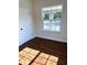Bedroom featuring vinyl plank flooring, a window and fresh paint at 1310 Polk City Rd, Haines City, FL 33844